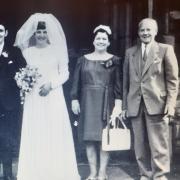 Her grandfather is stood to the front right of the bride and groom