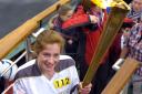 Torch bearer Stephanie Booth on the bow of the Tern on Windermere.