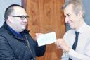 Nick Hartshorne-Evans (left) receives a cheque from Lancashire Telegraph assistant editor Nick Nunn.
