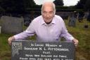 Frank Lomas with the collapsed headstone of Noel Leonard Pittendrigh at Flookburgh cemetery. Picture: JON GRANGER.