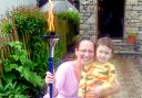 EXCITED: Taking an opportunity to shine a torch for the London Olympics in 2012 in her garden is Kendal mum Amanda Oversby and her son Grayson