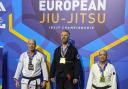 Mark Woods (centre) after winning gold at the European IBJJF Jiu-Jitsu Championship in Paris