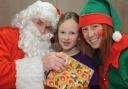 Madeleine King meets Santa and his helper at the school fayre