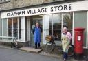 Cash help has in the past gone towards helping villagers in Clapham own and operate a community shop, seen here with volunteers David Kingsley and Sue Mann