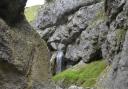 Gordale Scar - a dramatic limestone ravine containing two waterfalls with overhanging limestone cliffs more than 300-feet high.
