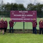 PROUD: Coaches Alastair Boston, Shona Taylor, Richard Belk, Jeff Jackson and Mark Kendrick stand by the new sign