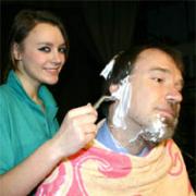 Pupil Emily Lane relieves her teacher Peter Rose of the beard he has been cultivating for more than two decades.