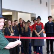 OPEN SESAME: School catering manager Miriam Stainton has the honour of officially opening the new lunch hall at The Lakes School, Troutbeck Bridge, watched by the design students and colleagues.