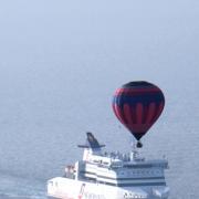 MAJESTIC: Ian Matthews and Martin Casson’s balloon rises above a cross-Channel ferry during their record-breaking crossing from Dover to Calais