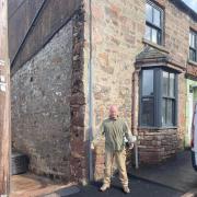 Paul Etheridge stood outside his home where the hole used to be for the electricity work