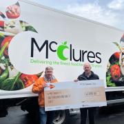 Ben McClure hands over the cheque to Andy Green of the MS Society