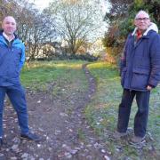 Kendal Town Councillors Eamonn Hennessy (left) and Giles Archibald (right) at Vicarage Drive open space, recently acquired by the council