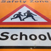 A stock image of a school road sign
