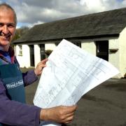 Lt Col Guy Harnby studies plans for his changes at Tarnside Farm, Crosthwaite