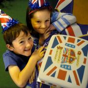 Maya and Lucas Schofield with the cake their mum made for the party