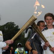 Olympic Torch in Ambleside: Tom Wright passes the flame onto Stephanie Booth