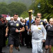 Philip Barker carries the torch in Grasmere.