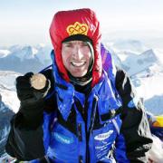 Kenton Cool with the medal at the summit of Everest