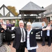 Staff celebrate the arrival of the first two new Kia 4x4s