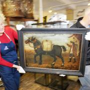 On the move: Museum curator Carol Davies and volunteer Tony Riley with the painting 'The Bell Mare'