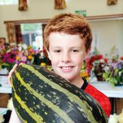 Jack Casson with the giant marrow grown by Dr Kevin Briggs at Bolton-le-Sands Floral and Horticultural Society Show
