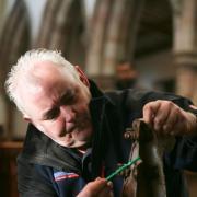 A specialist flood restorer attends to the eagle lectern at St Lawrence's Church, Appleby. (Picture: Richfords Fire and Flood)