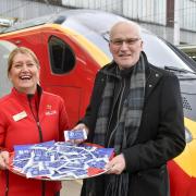 Cath Broughton, from Virgin Trains, with John Whittle, a trustee of the Cumbria Community Foundation, with some Kendal mintcake.