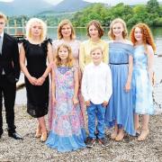 Members of the cast of Swallows and Amazons on the shoreline at Keswick prior to the world premiere