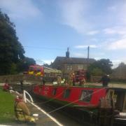 Firefighters help the barge at Gargrave. Picture tweeted by Tony Peel of North Yorkshire Fire and Rescue Service