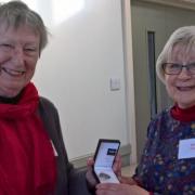 Mary Hindle handing over the president’s badge to new president Kate Croll