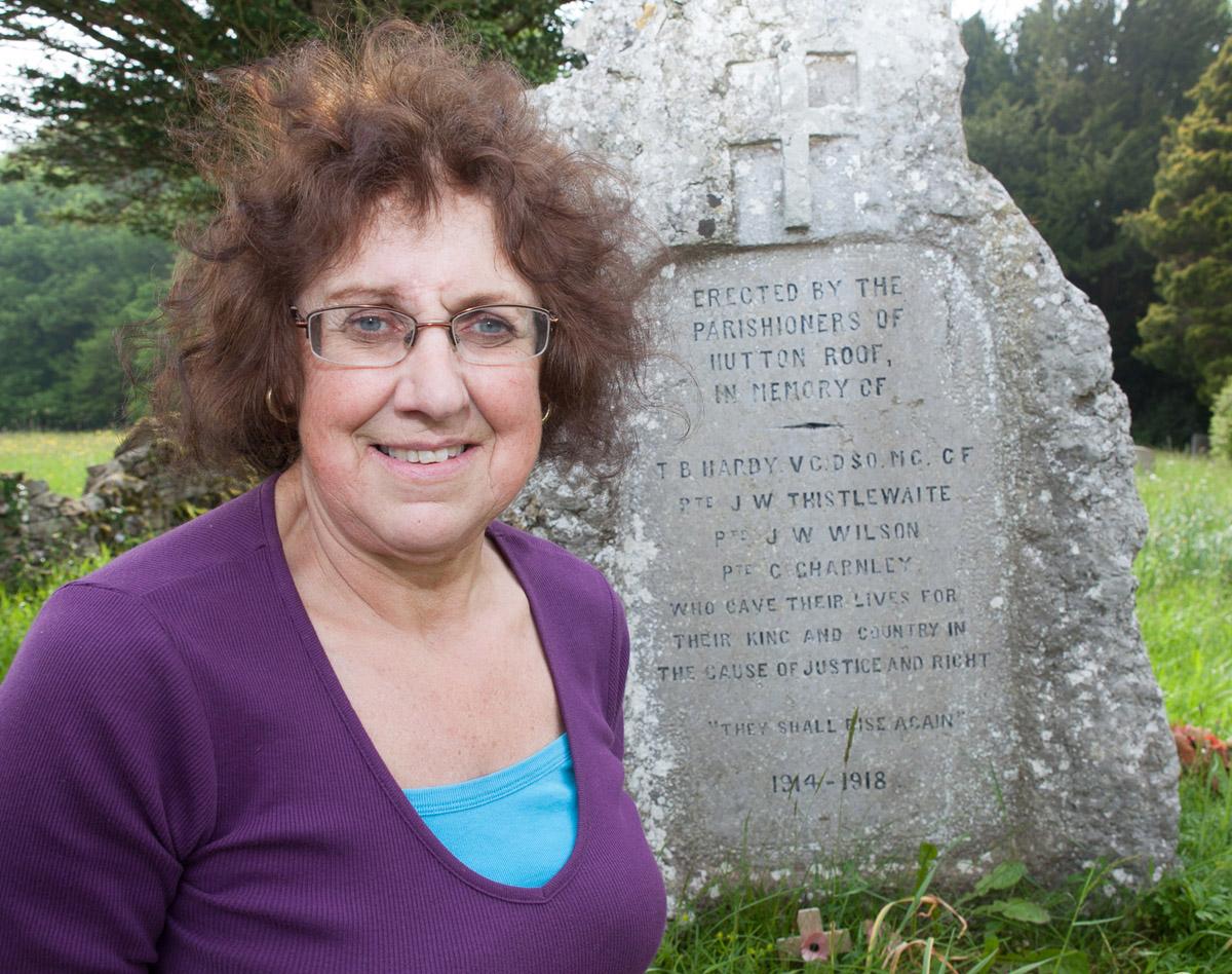 Hutton Roof churchwarden Anne Huntington at the village's war memorial