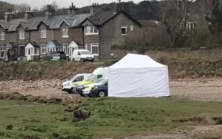 Police at the scene on Cove Road Beach