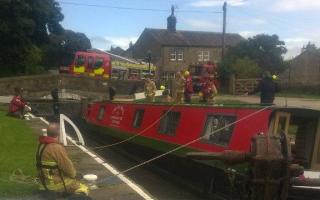 Firefighters help the barge at Gargrave. Picture tweeted by Tony Peel of North Yorkshire Fire and Rescue Service