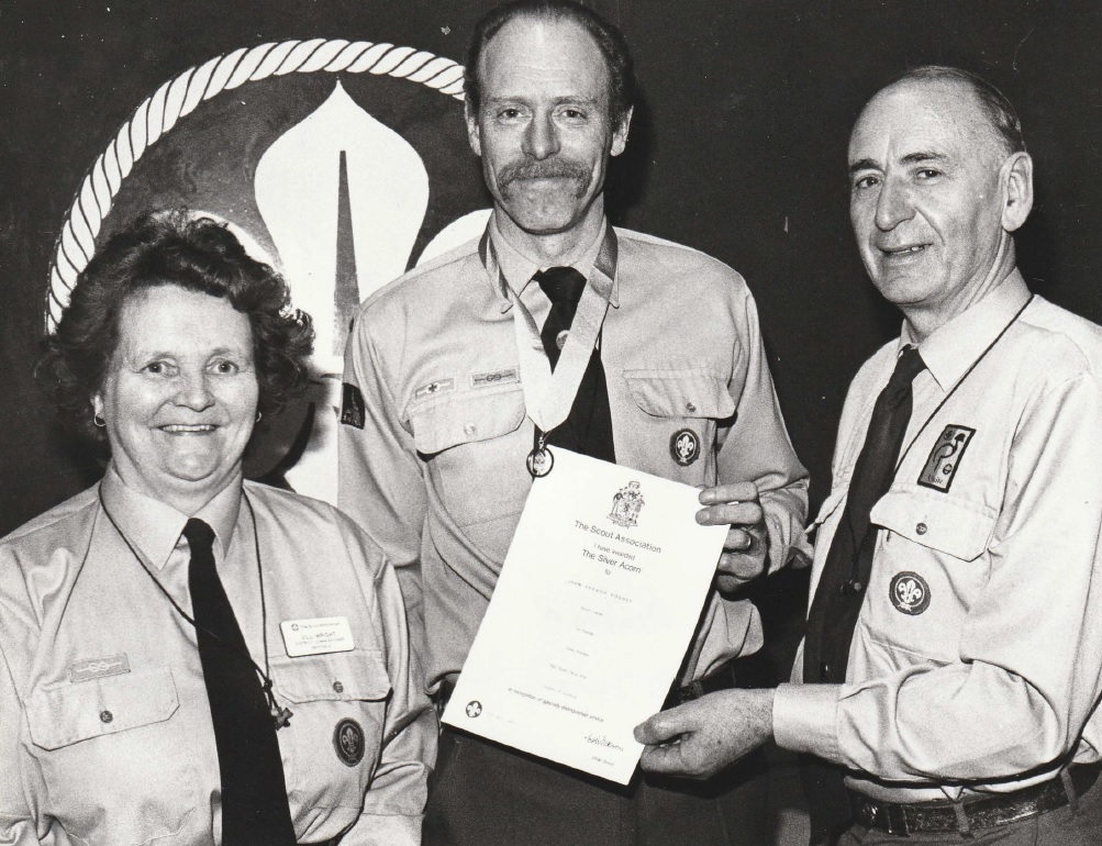 AWARD: Trevor Hughes (centre), leader of 1st Kendal Scout Troop, receiving his silver acorn award in 1994