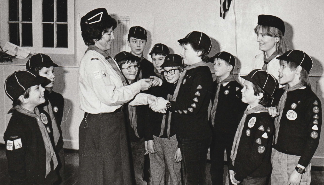 GOLD: Tony Arthy of the 1st Ambleside Cub Scout pack receiving his Gold Arrow award from Akela Pauline Brindle in 1987. Looking on are the rest of the pack members and Bagheera Helen Tailforth