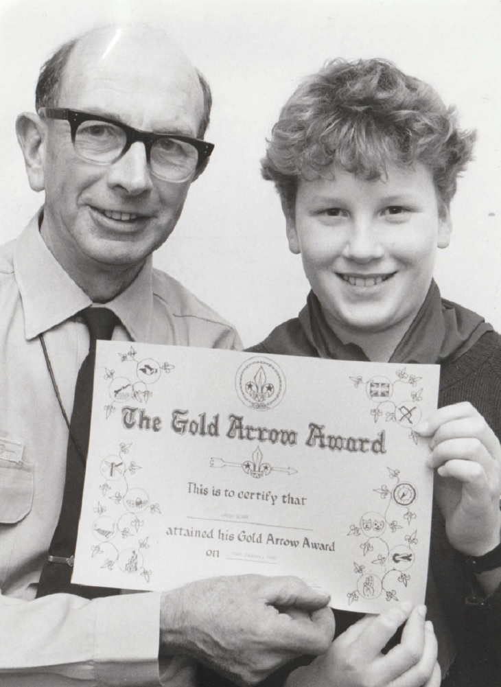 AWARDED: Ten-year-old David Scarr, of 1st Sedbergh Cubs, receiving his Gold Arrow award from group scout leader Dick Marks in 1990