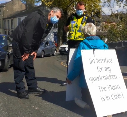 CLIMATE: Janet Antrobus blocking traffic on New Rd in Kendal in solo climate protest
