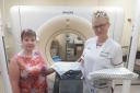 Treatment delivery team leader Kelly Littlefair (right) hands over the radiotherapy department’s stock of new Rosemere Cancer Foundation-funded gowns to treatment planning team leader Catherine Abbott