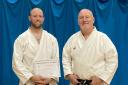 KARATE: Chris Greenbank proudly showing his 2nd Dan Black Belt Grading Certificate alongside with Doug James 8th Dan Chief Instructor