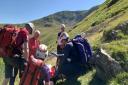 Mountain rescue teams combine to help walker after plunging down waterfall