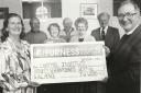 First Grange and Cartmel Scouts donated Â£97.64 from the proceeds of their coffee morning to the roof fund of the Cartmel Institute in 1997. Scout committee member Eunice Mullagh presents the cheque to Vicar of Cartmel Cannon Christopher