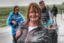 Woman on Cross Bay Walk holding up Compeed but still looking happy