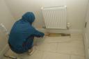 Mehreen Naeem inspects the uneven flooring and files lifting in her downstairs toilet.