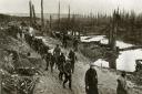 Border Regiment troops advance cautiously along the Menin Road in Flanders in 1918