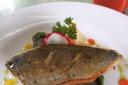 Pan fried Seabass fillet on a radish, fennel and rocket salad with pepper coulis and herb oil