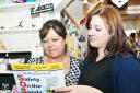 Gazette reporter Anna Clarke hands a copy of the poster to Elizabeth McGonagle at The Little Shop, Arnside