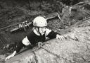CLIMB: Claire Russell, ten, wears face paint as she tries out rock climbing at Lakeside YMCA in 1993