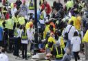 Medical workers help the injured near the Boston Marathon finish line