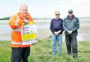 Mike Davis, training officer for Bay Search and Rescue, Queen’s Guide Cedric Robinson and Nigel Capstick, station officer for Arnside Coastguard, with a copy of The Westmorland Gazette Safety on the Sands poster