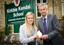 Former Kirkbie Kendal School pupil Heather Ramsay accepts her business prize from Karl Burrell of Lamont Pridmore.